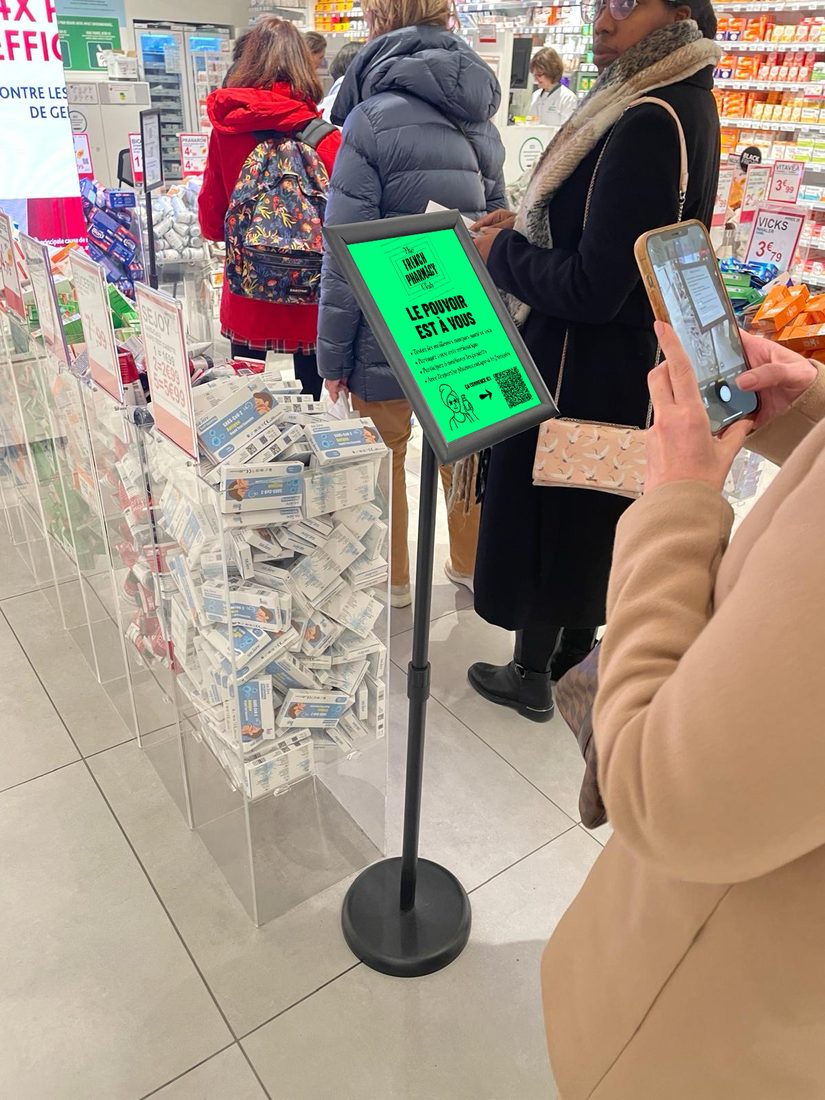 Une cliente scanne le QR code du Club sur un chevalet en surface de vente